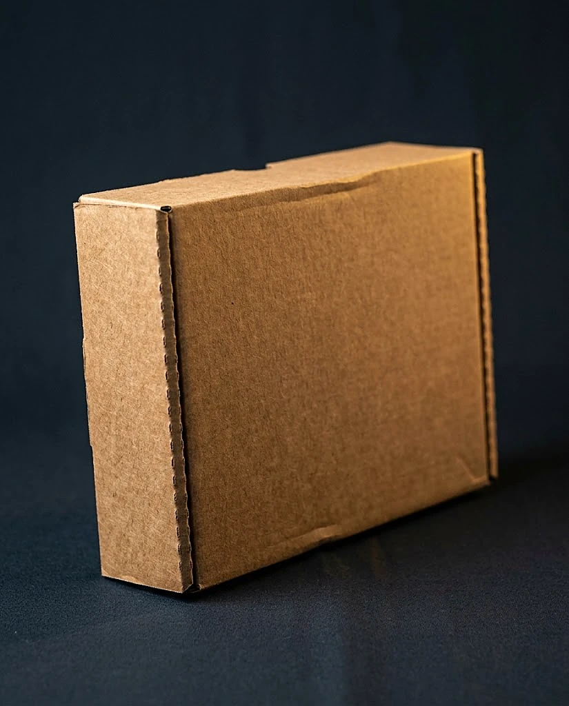 Custom kraft mailer box, closed, natural unbleached E-flute corrugated with visible flute texture
